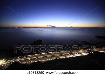 Stock Image - Coastal Road and Ocean at Twilight. Fotosearch