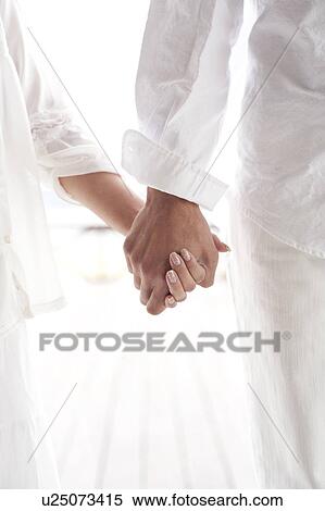 Stock Photography - Couple holding hands. Fotosearch