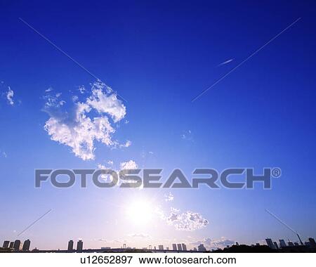 Stock Photo - Cumulus Clouds Over City. Fotosearch