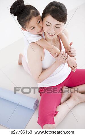 Stock Image - Daughter Hugging Mother. Fotosearch