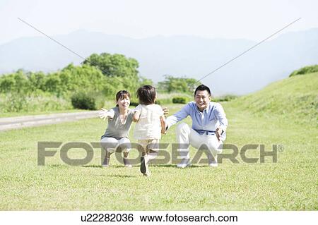 Stock Photograph - Daughter running to parents. Fotosearch