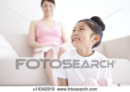 Daughter Smiling, Mother in Background View Large Photo Image Stock Photo - Daughter Smiling, Mother in Background. Fotosearch