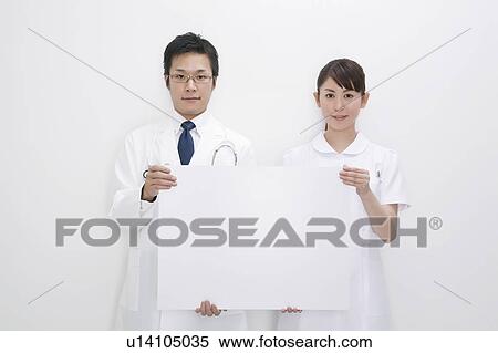 Doctor and nurse holding blank cardboard View Large Photo Image Stock Photography - Doctor and nurse holding blank cardboard. Fotosearch
