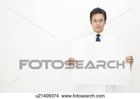 Picture - Doctor holding blank cardboard. Fotosearch