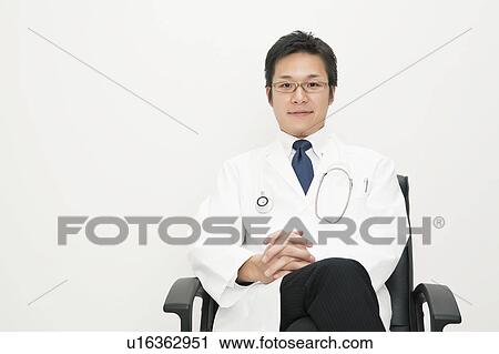 Stock Image - Doctor sitting on chair. Fotosearch