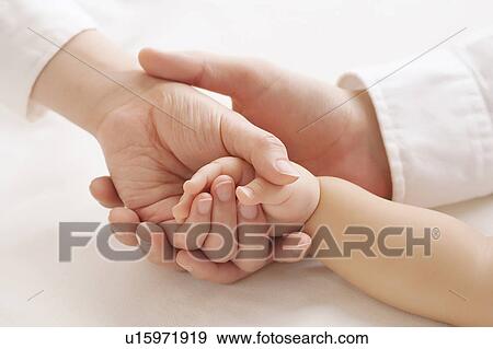 Family holding each other's hands View Large Photo Image Stock Photo - Family holding each other's hands. Fotosearch