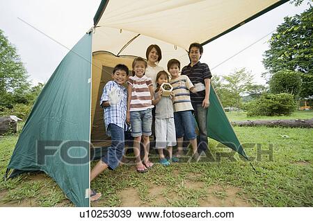 Stock Photo - Family in front of tent, Chiba Prefecture, Honshu, Japan. Fotosearch