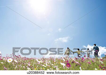 Stock Image - Family of Four in Flower Field. Fotosearch