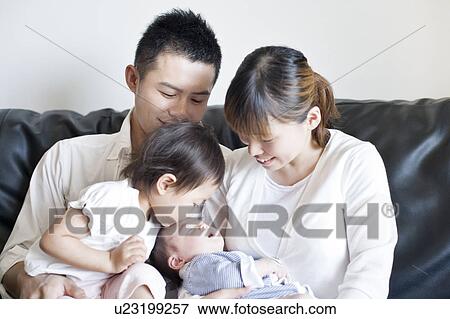 Family sitting on sofa View Large Photo Image Stock Photo - Family sitting on sofa. Fotosearch