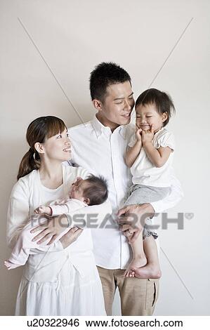 Family standing and smiling View Large Photo Image Stock Photograph - Family standing and smiling. Fotosearch