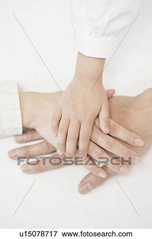 Family with hand on top of each other View Large Photo Image Stock Photo - Family with hand on top of each other. Fotosearch
