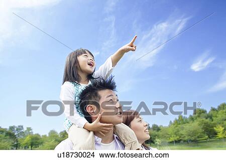 Picture - Father carrying daughter on shoulders. Fotosearch