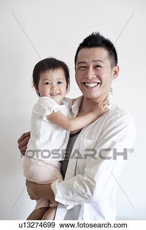 Stock Photo - Father carrying daughter. Fotosearch