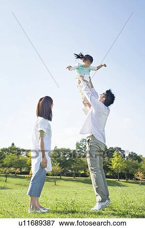 Stock Photo - Father lifting up daughter. Fotosearch