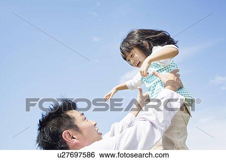 Father lifting up daughter View Large Photo Image Stock Photograph - Father lifting up daughter. Fotosearch