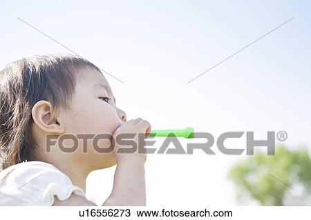 Girl holding a bubble wand View Large Photo Image Stock Image - Girl holding a bubble wand. Fotosearch