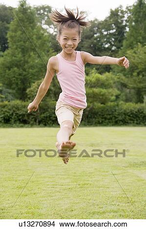 Picture - Girl jumping, Chiba Prefecture, Honshu, Japan. Fotosearch