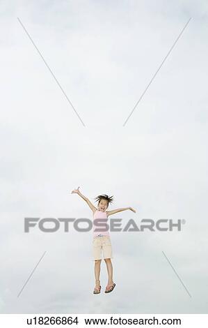 Girl jumping, Chiba Prefecture, Honshu, Japan View Large Photo Image Picture - Girl jumping, Chiba Prefecture, Honshu, Japan. Fotosearch