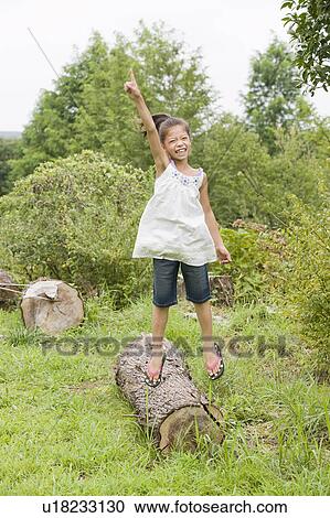 Stock Image - Girl jumping, Chiba Prefecture, Honshu, Japan. Fotosearch