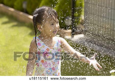 Girl playing with sprinkler, Chiba Prefecture, Honshu, Japan View Large Photo Image Stock Image - Girl playing with sprinkler, Chiba Prefecture, Honshu, Japan. Fotosearch