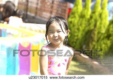 Girl playing with sprinkler, Chiba Prefecture, Honshu, Japan View Large Photo Image Stock Photography - Girl playing with sprinkler, Chiba Prefecture, Honshu, Japan. Fotosearch