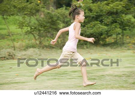 Stock Photograph - Girl running, Chiba Prefecture, Honshu, Japan. Fotosearch