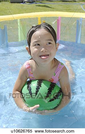 Stock Photography - Girl swimming in wading pool, Chiba Prefecture, Honshu, Japan. Fotosearch