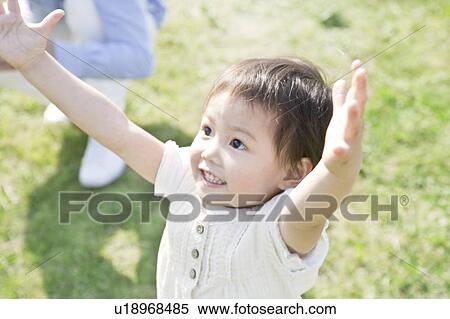 Girl with arms raised View Large Photo Image Stock Photography - Girl with arms raised. Fotosearch