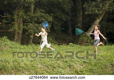 Picture - Girls running with butterfly nets, Chiba Prefecture, Honshu, Japan. Fotosearch