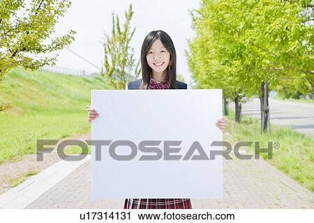 Stock Image - High School Girl Holding Blank Message. Fotosearch