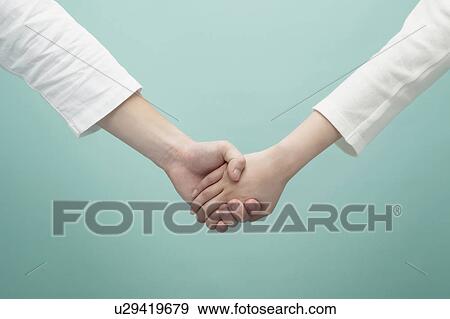 Stock Photo - Holding hands. Fotosearch