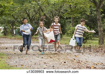 Stock Image - Kids carrying bottles of water and food, Chiba Prefecture, Honshu, Japan. Fotosearch