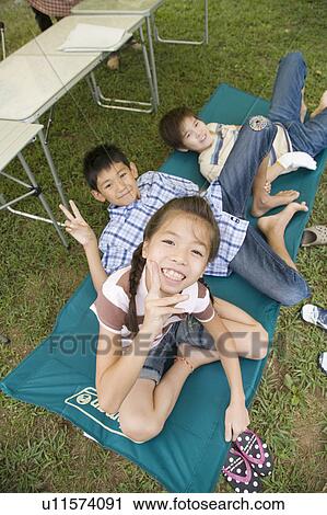 Stock Image - Kids looking at camera, Chiba Prefecture, Honshu, Japan. Fotosearch