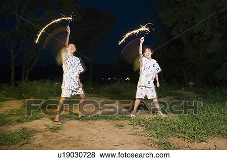 Stock Photo - Kids playing with firework, Chiba Prefecture, Honshu, Japan. Fotosearch