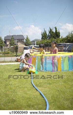 Kids playing with sprinkler, Chiba Prefecture, Honshu, Japan View Large Photo Image Stock Photo - Kids playing with sprinkler, Chiba Prefecture, Honshu, Japan. Fotosearch