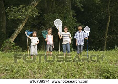 Picture - Kids standing with butterfly nets to catch insects, Chiba Prefecture, Honshu, Japan. Fotosearch