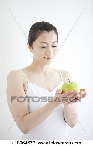 Stock Image - Mature Woman Having Apple. Fotosearch