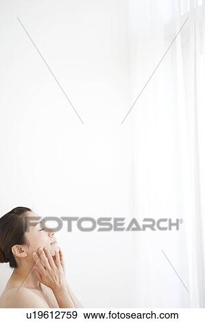 Stock Photo - Mature Woman Touching Her Face. Fotosearch