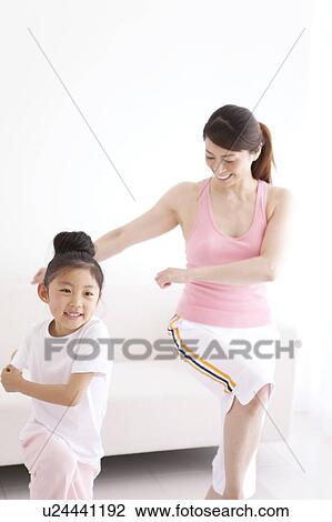 Stock Image - Mother and Daughter Doing Aerobics. Fotosearch