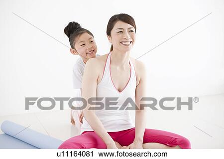 Stock Image - Mother and Daughter Exercising. Fotosearch