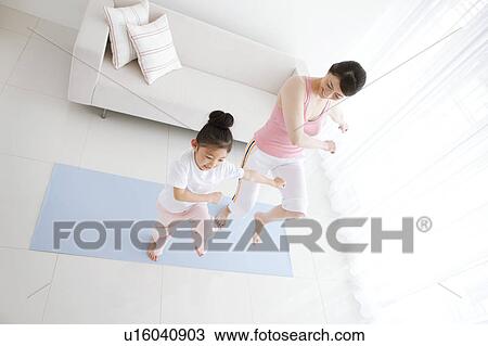 Stock Image - Mother and Daughter Exercising. Fotosearch