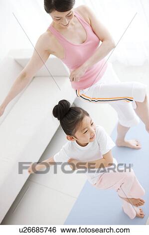 Stock Photograph - Mother and Daughter Exercising. Fotosearch