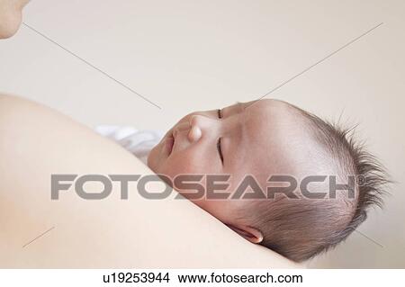 Picture - Mother carrying baby. Fotosearch
