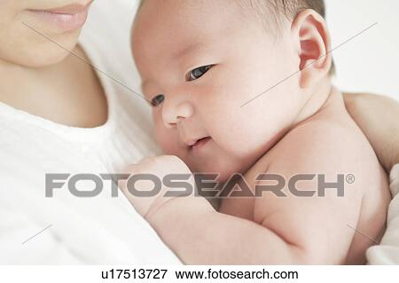 Mother carrying baby View Large Photo Image Stock Photo - Mother carrying baby. Fotosearch
