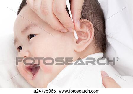 Stock Photography - Mother Cleaning Baby's Ear. Fotosearch