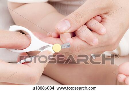 Mother Cutting Baby's Fingernails View Large Photo Image Picture - Mother Cutting Baby's Fingernails. Fotosearch