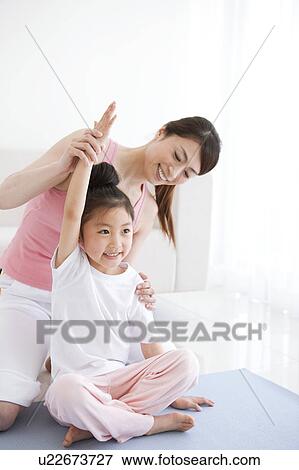 Mother Guiding Daughter in Exercising View Large Photo Image Stock Photo - Mother Guiding Daughter in Exercising. Fotosearch