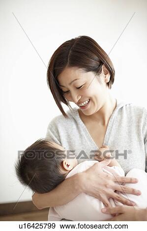 Stock Photo - Mother Holding Baby Boy. Fotosearch