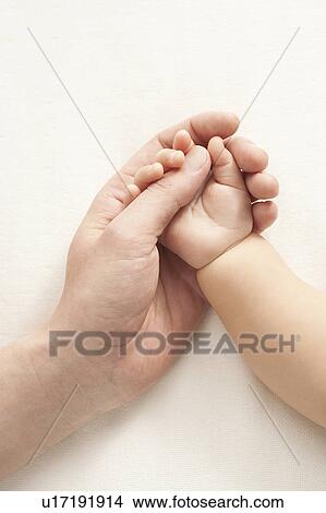 Mother holding baby's hand View Large Photo Image Picture - Mother holding baby's hand. Fotosearch