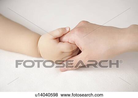 Mother holding baby's hand View Large Photo Image Stock Photo - Mother holding baby's hand. Fotosearch